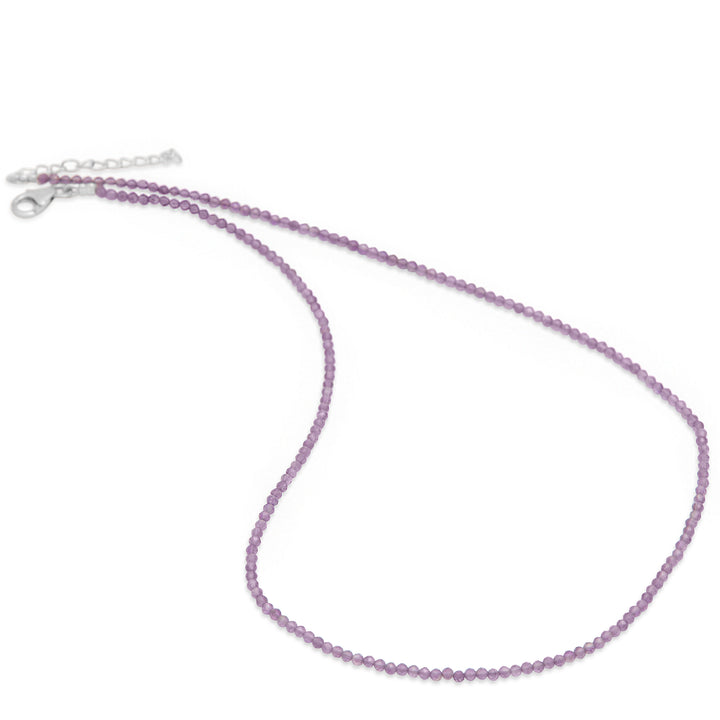 Purple beaded necklace on a white background