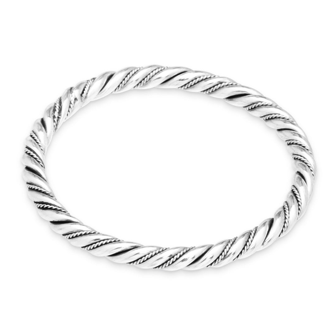 Silver ring with a twisted design on a white background