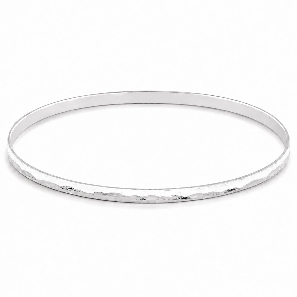  A feminine, dainty bangle with a flat, hammered plemished finish in high quality sterling silver 
