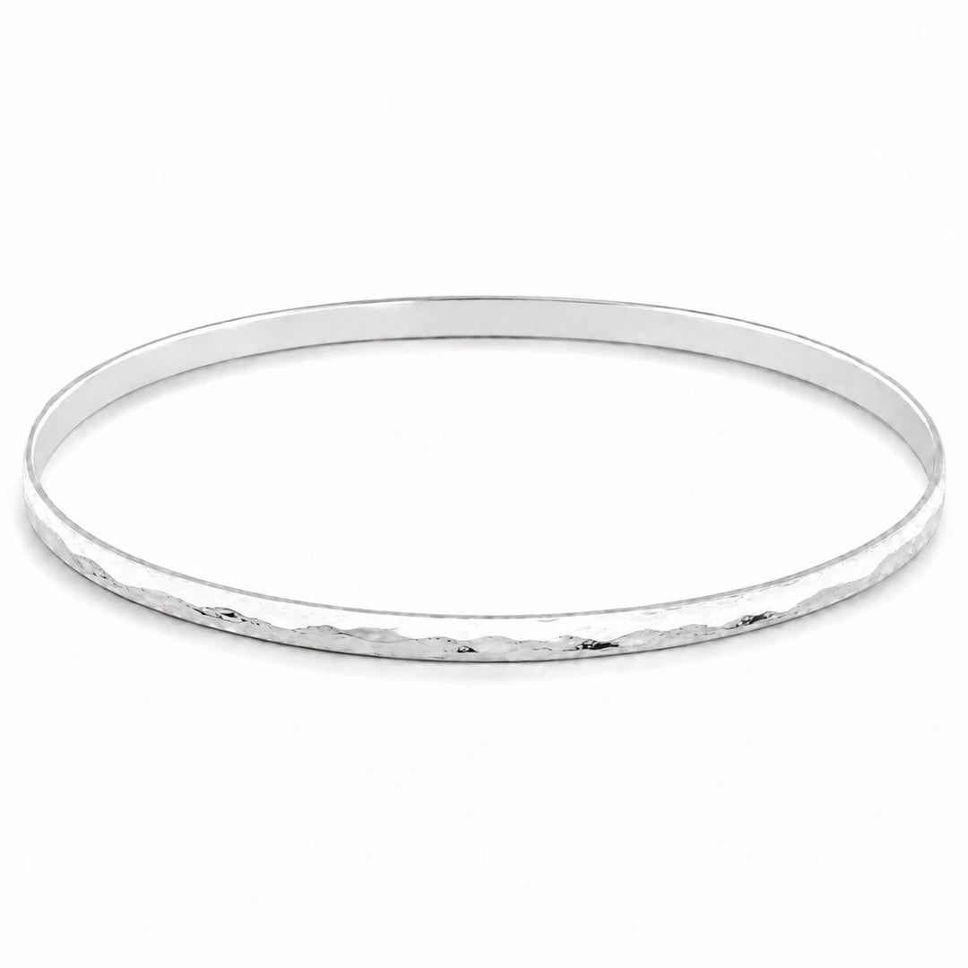  A feminine, dainty bangle with a flat, hammered plemished finish in high quality sterling silver 