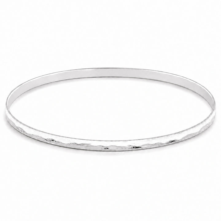  A feminine, dainty bangle with a flat, hammered plemished finish in high quality sterling silver 