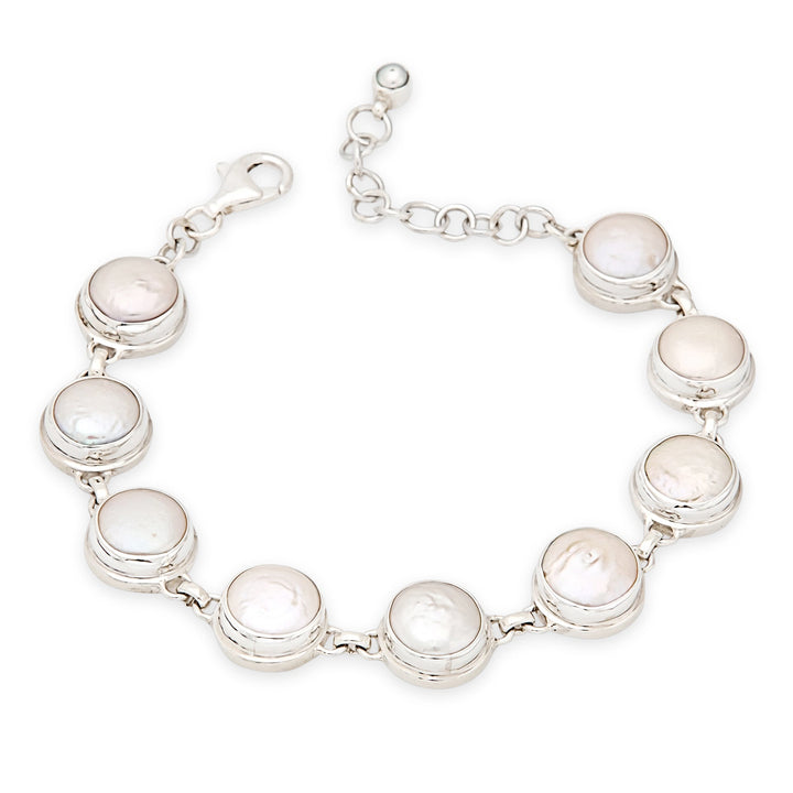 Silver bracelet with round white stones on a white background