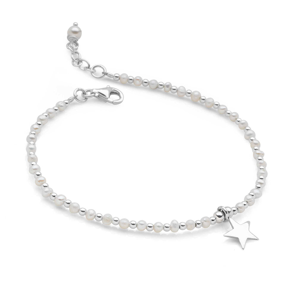 Pearl bracelet with a star charm on a white background