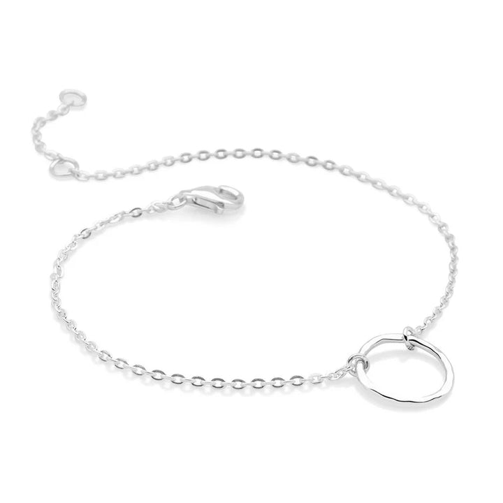 Silver bracelet with a round clasp on a white background