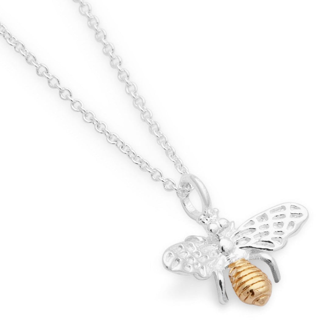 Silver bee pendant necklace with gold accents on a white background