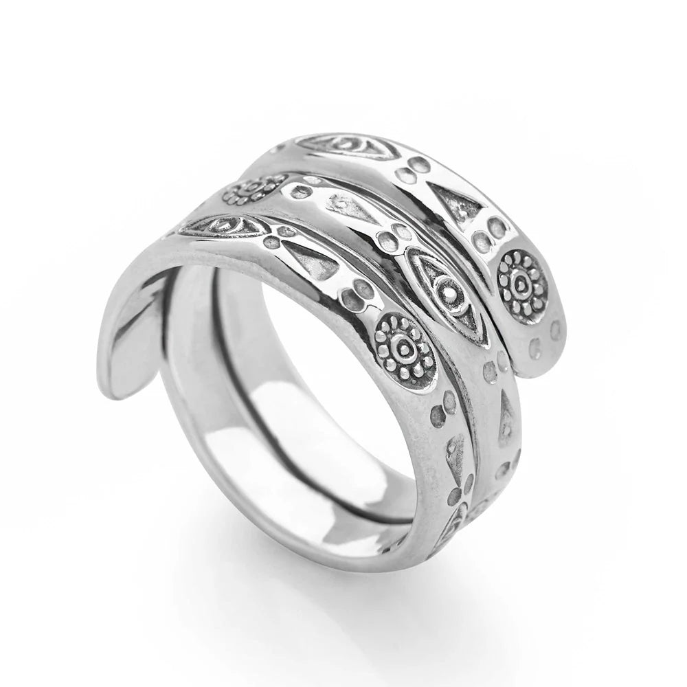 A silver ring with a wrap band style, featuring hand-stamped spiritual symbols.