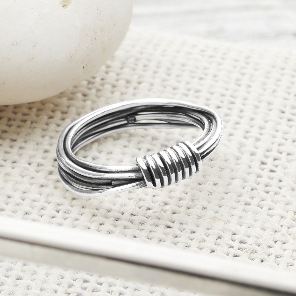A sterling silver ring with a twisted design and a high polish finish.