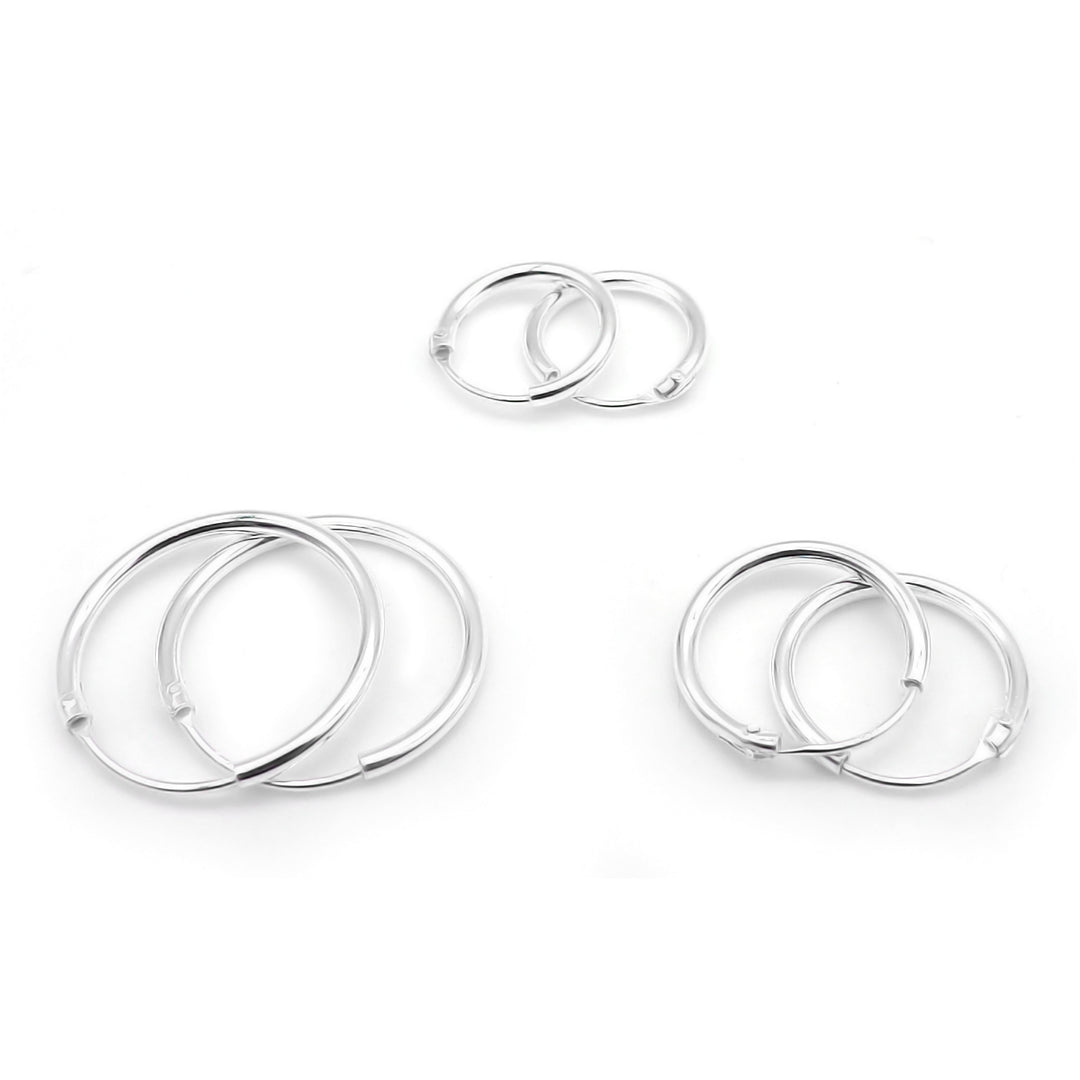 A set of sterling silver hoop earrings in a high polish finish, with secure clip fastenings, displayed on a white background.