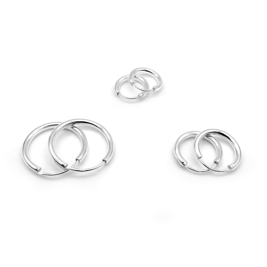 Three pairs of sterling silver hoop earrings with high polish finish, displayed on a white background.