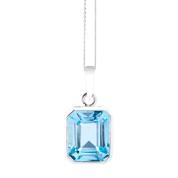 Blue topaz pendant on white background. 