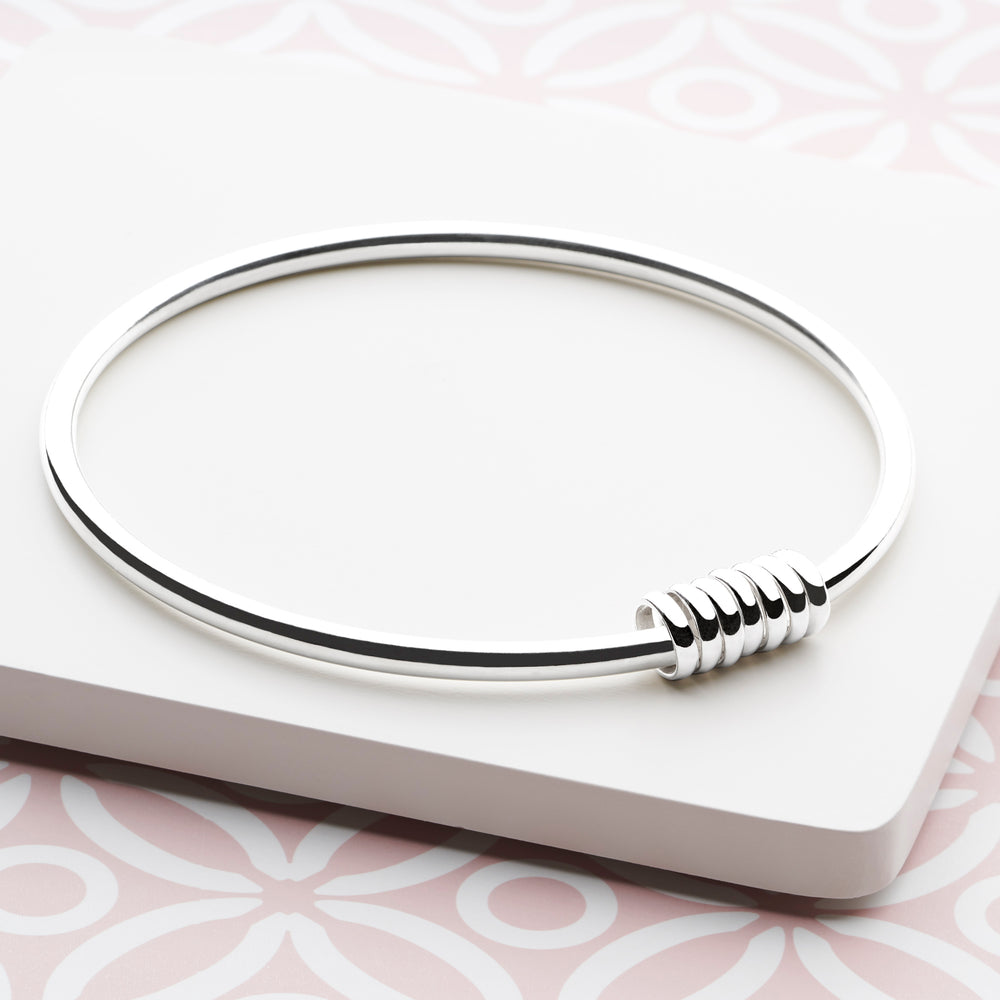 Sterling Silver Ring Around Bangle. Neutral background. 