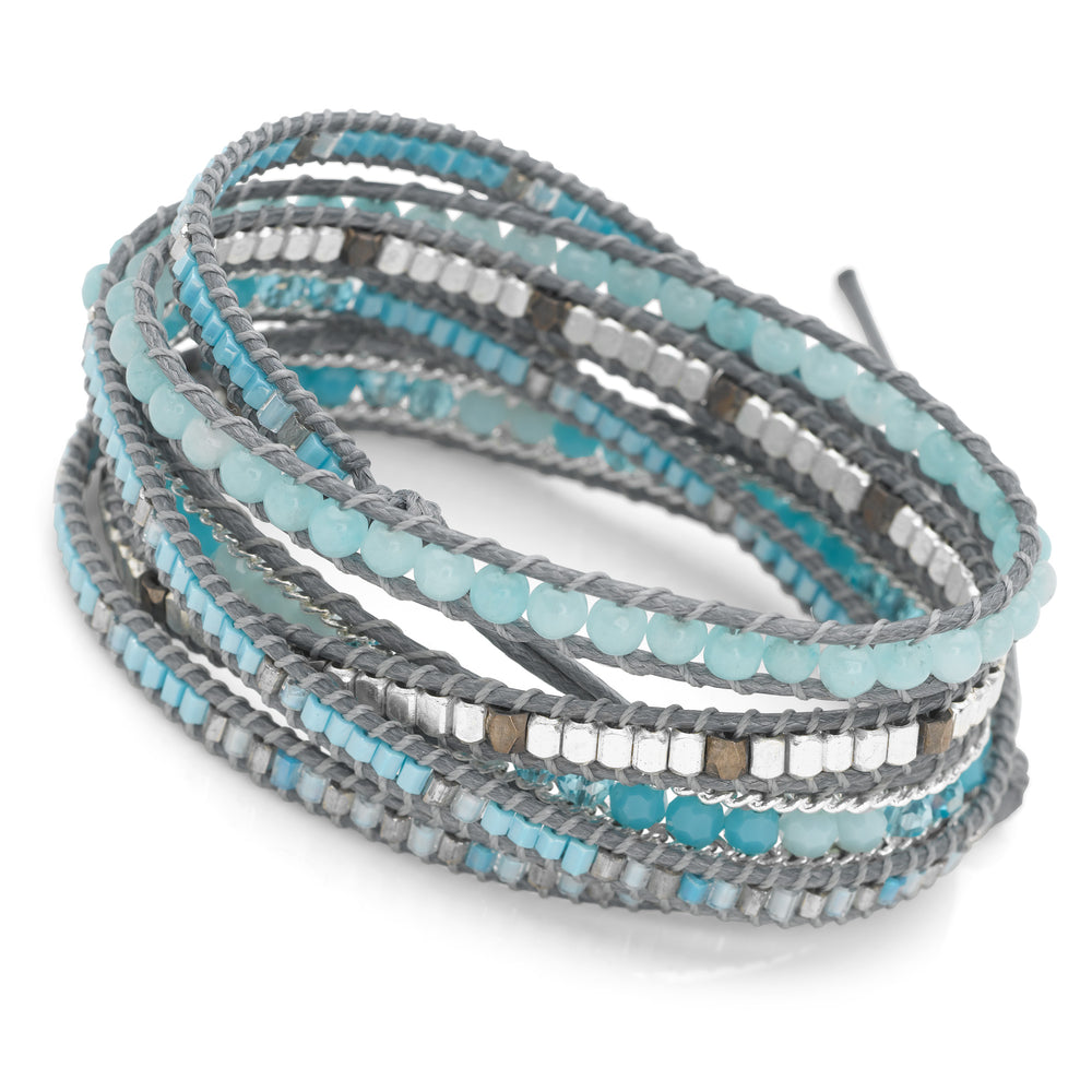 A wrap bracelet with semi precious blue beads and silver accents, fastened with a shiny 925 sterling silver disc button & secure loop.