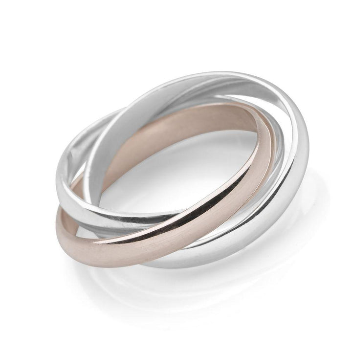 Two interlocking sterling silver bands and a single pale rose gold band ring