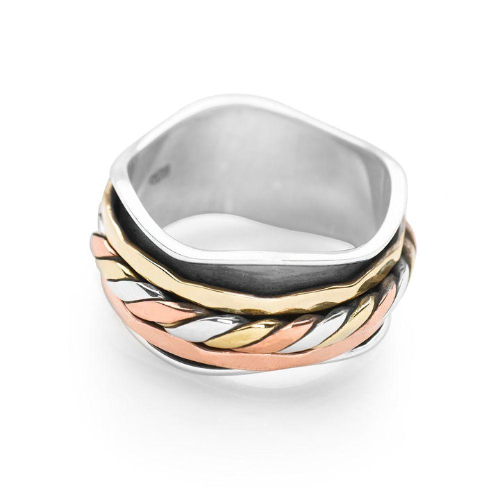 A wavy 925 sterling silver cuff, wrapped with bands of twisted silver, brass and copper which move freely spin ring